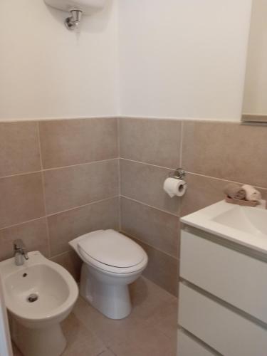 a bathroom with a toilet and a sink at Affittacamere Lusitana Alloggi 2 in Foligno