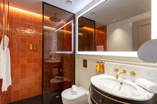 a bathroom with a sink and a toilet and a mirror at Upon Angels - Adults Only in Lisbon
