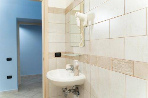 a bathroom with a sink and a phone on the wall at The Brothers B&B in Ercolano