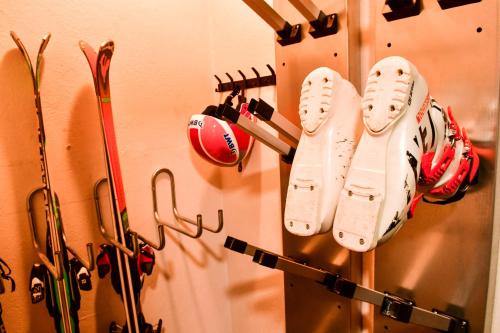 a group of baseball equipment hanging on a wall at Villa du Parc le Châtaignier in Formiguères