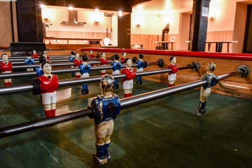 a group of wooden manicans in a wrestling match at Villa du Parc le Châtaignier in Formiguères