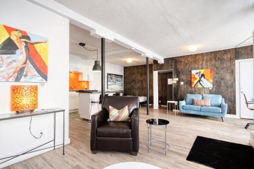 a living room with a couch and a chair at Loft de l'Antiquaire by Hébergements DCL in Quebec City