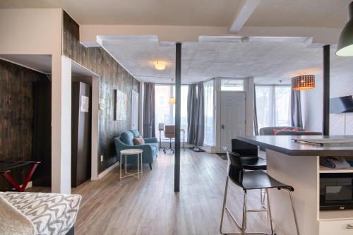 a kitchen and living room with a table and chairs at Loft de l'Antiquaire by Hébergements DCL in Quebec City