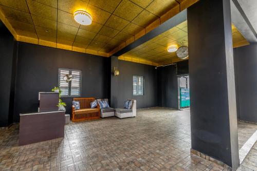 a lobby with couches and chairs in a building at W&H View Residency in Cochin