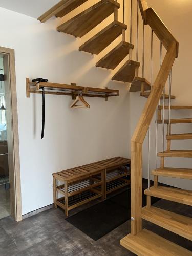 a wooden staircase in a room with a wooden bench at Ferienhaus Am Nationalpark 8A in Klausdorf Mecklenburg Vorpommern