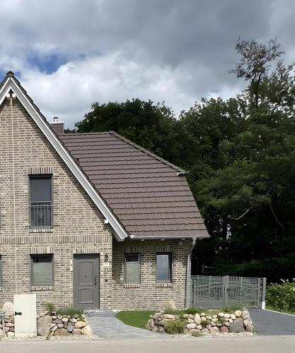 a brick house with a brown roof at Ferienhaus Am Nationalpark 8A in Klausdorf Mecklenburg Vorpommern