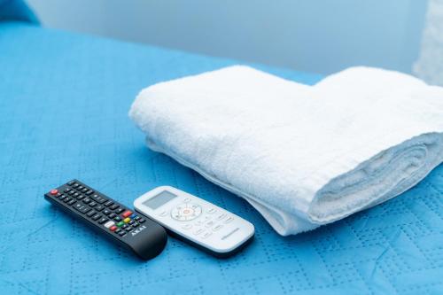 two remote controls and a pillow on a bed at The Brothers B&B in Ercolano