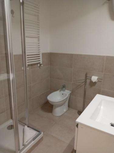 a bathroom with a shower and a toilet and a sink at Affittacamere Lusitana Alloggi 2 in Foligno