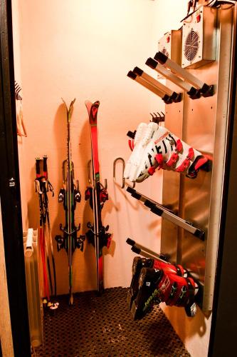 a room with skis and skis hanging on a wall at Villa du Parc le Frêne in Formiguères