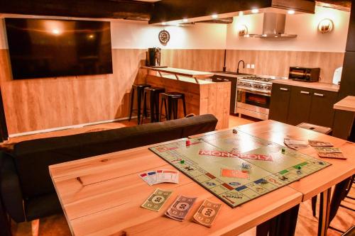 a kitchen with a wooden table with money on it at Villa du Parc le Frêne in Formiguères