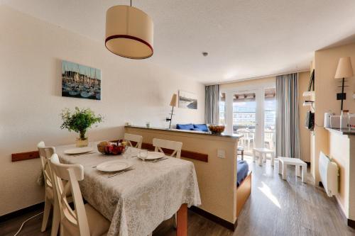 une cuisine et une salle à manger avec une table et des chaises dans l'établissement Appartement vue mer à 400m de la plage du Fogeo, à Arzon