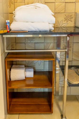 a glass shelf with towels on top of it at W&H View Residency in Cochin
