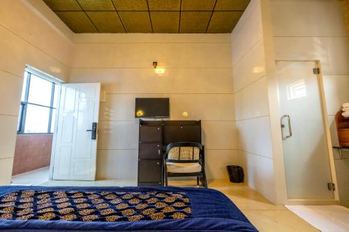 a bedroom with a bed and a window and a door at W&H View Residency in Cochin