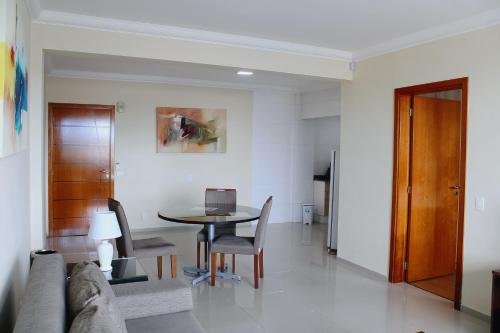 a living room with a table and a couch at Apart Hotel Acrópolis in Santana do Livramento