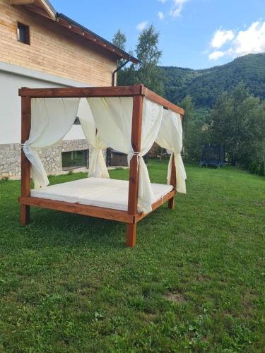 a bed in the grass in a yard at Bran Mountain Living in Bran