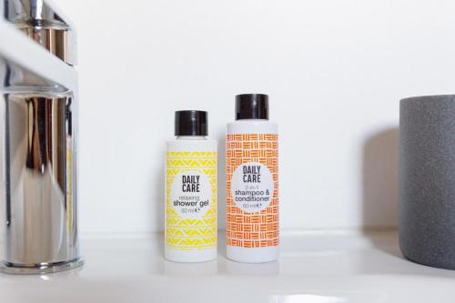 two bottles of hair products sitting on a counter at La Nuit du Drouais in Dreux