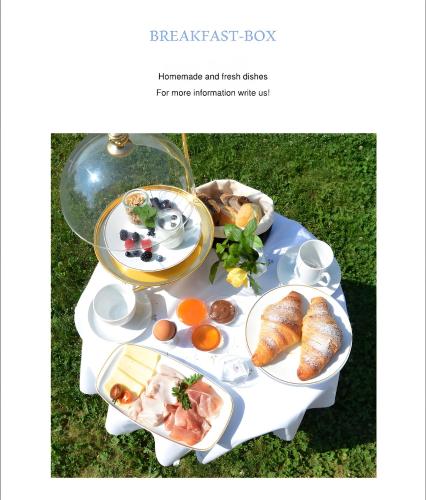 a plate of breakfast foods on a table at App. Col Toronn - Ciasa Lavarella in San Vigilio Di Marebbe