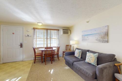 a living room with a couch and a table at Unit 117 for Poolside Fun in Wells