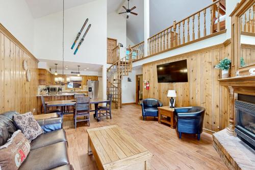 a living room with a couch and a fireplace at Snowfire 308A in Angel Fire