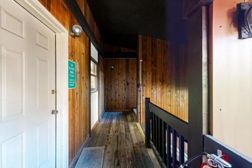 a hallway of a house with wooden walls and a door at Snowfire 308A in Angel Fire