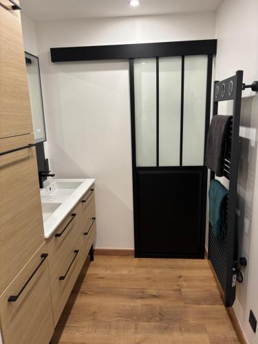 a kitchen with a black door and a sink at Villa La Liberté in Arles-sur-Tech