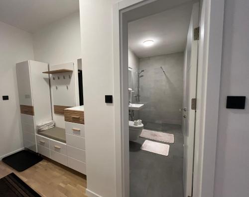 a white bathroom with a toilet and a sink at Ilidža Residence Luxury Apartment in Sarajevo
