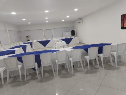 a blue and white table and chairs in a room at Hotel Sabana del Sinu By GEH Suites in Montería