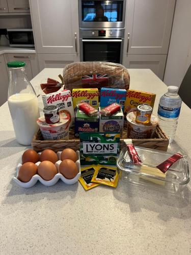 a counter with eggs and other food and milk at The Coach House at BYRE HOUSE in Coalpit Heath