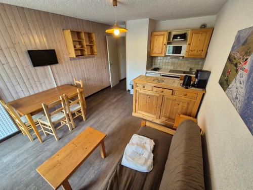 un salon avec un canapé et une table et une cuisine dans l'établissement Studio fonctionnel avec balcon, animaux admis - FR-1-811-25, à Les Deux Alpes