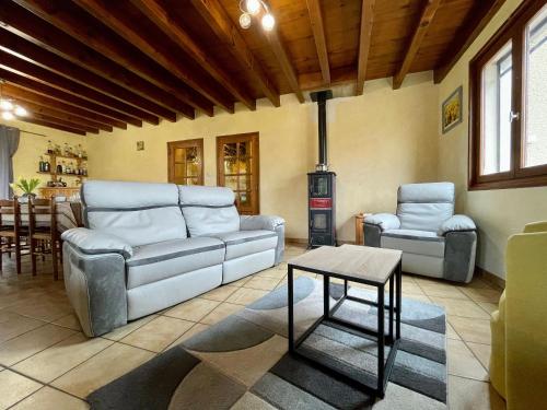 a living room with a couch and chairs and a table at Chambre Lilas à Alleyras - Animaux admis, Table d'hôtes, Terrains spacieux - FR-1-582-514 in Alleyras