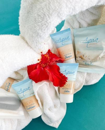 a group of four moisturizing products sitting on towels at Hôtel AFRICA QUEEN in Somone