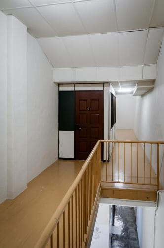 an empty room with a staircase and a brown door at Aayu Pantai - George Town, Penang in George Town