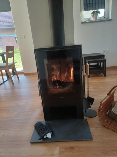 a fireplace in the middle of a living room at Hiša Štolc in Gornja Radgona