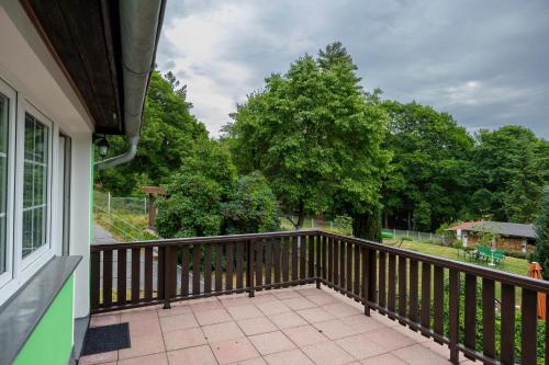 a balcony with a view of a yard at Pension U Golfu Cihelny in Karlovy Vary