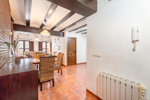 a dining room and living room with a table and chairs at Cueva Del Gollisno in Chulilla