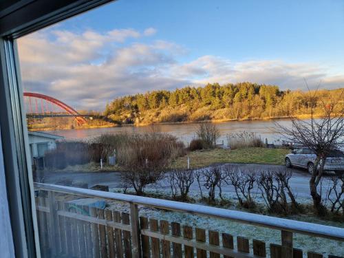 a view from a window of a river and a bridge at Trevligt fritidshus med underbar utsikt in Gothenburg