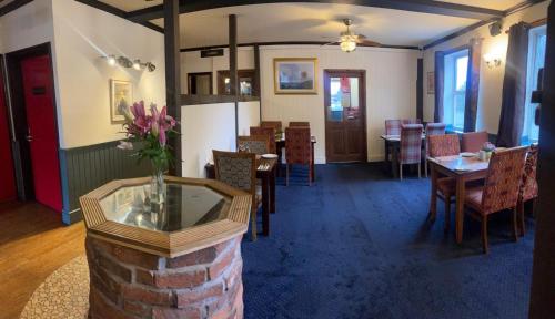 a dining room with tables and chairs and a brick pillar at Leaking Well, Dunhampton in Stourport
