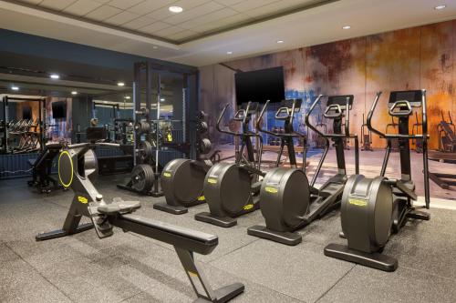 a gym with a bunch of treadmills and machines at Hilton Dublin Kilmainham in Dublin