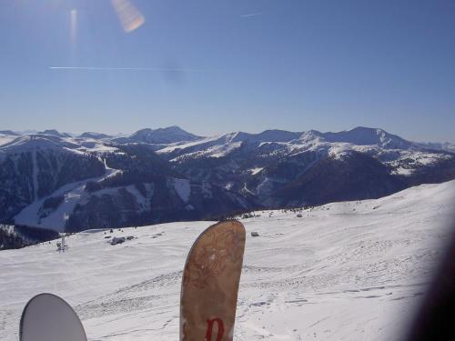 a snowboard standing on top of a snow covered mountain at Apartment Almhaus Innerkrems in Innerkrems