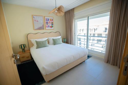 a bedroom with a bed and a large window at Noreba Hospitality in Tangier