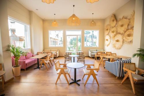 a restaurant with tables and chairs and windows at Noreba Hospitality in Tangier