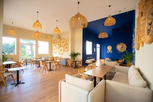 a restaurant with blue walls and tables and chairs at Noreba Hospitality in Tangier