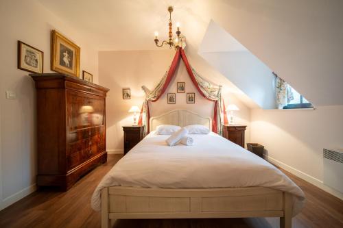 a bedroom with a large bed in a attic at Les calèches de l'Hôtel de Beaumont in Valognes
