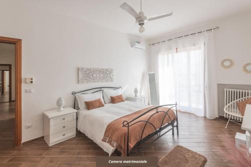a white bedroom with a bed and a window at Pappacoda 7 - Lecce Selection in Lecce