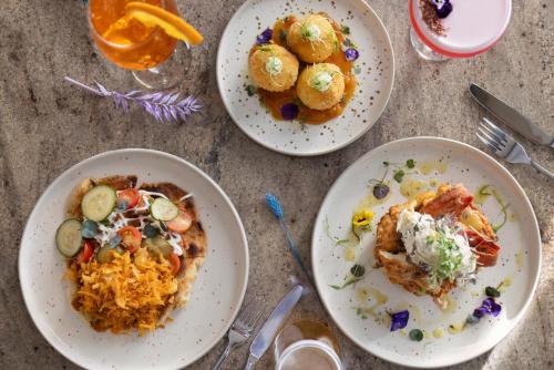 three plates of food sitting on a table at Hilton Dublin Kilmainham in Dublin