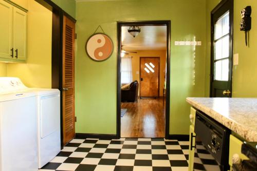 a kitchen with green walls and a checkered floor at The Flower Pot in Lexington