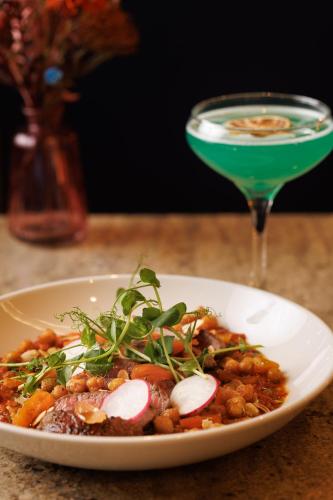 a plate of food on a table with a drink at Hilton Dublin Kilmainham in Dublin