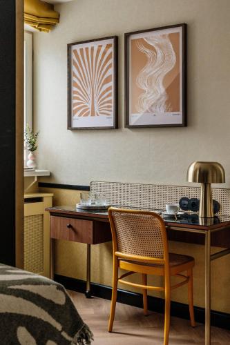 a room with a table and a chair and a desk at Colette - LoftAffair Collection in Warsaw