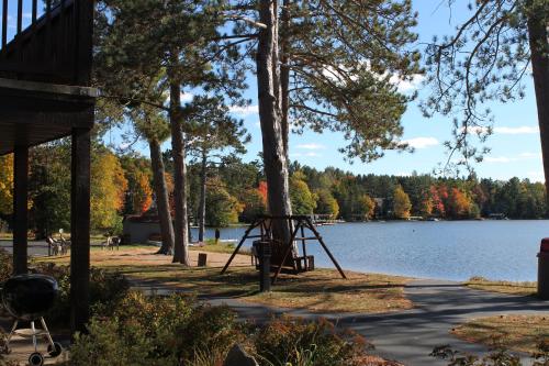 a park with a playground next to a lake at 2 Bedroom Lower Lakefront Condo, Wild Eagle Lodge #116 in Eagle River