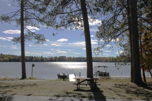 a picnic table in front of a lake with boats at 2 Bedroom Lower Lakefront Condo, Wild Eagle Lodge #116 in Eagle River